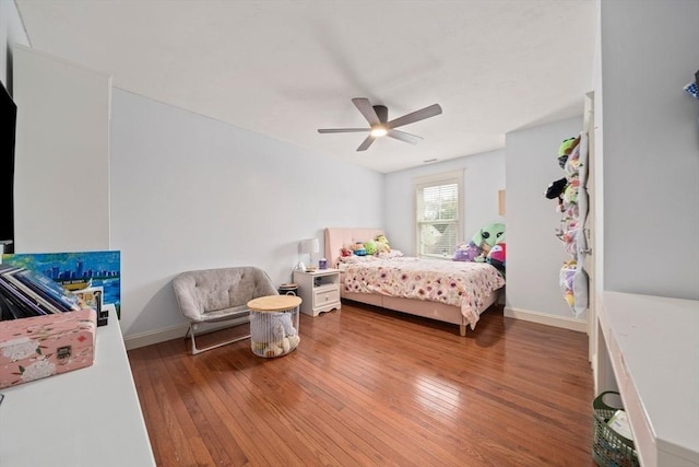 bedroom featuring wood-type flooring, baseboards, and ceiling fan