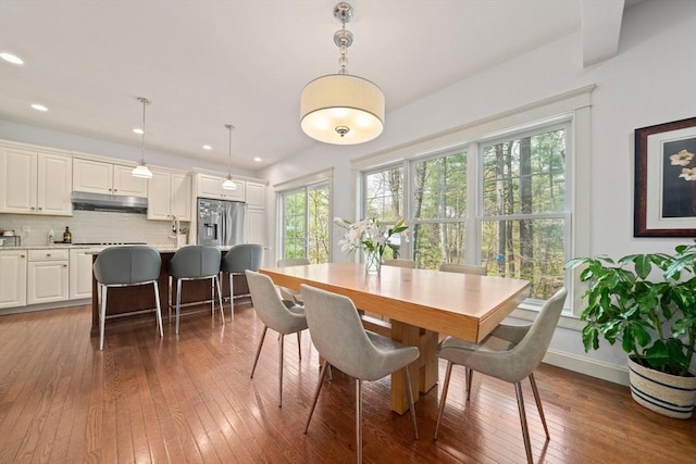 dining space with recessed lighting and hardwood / wood-style flooring