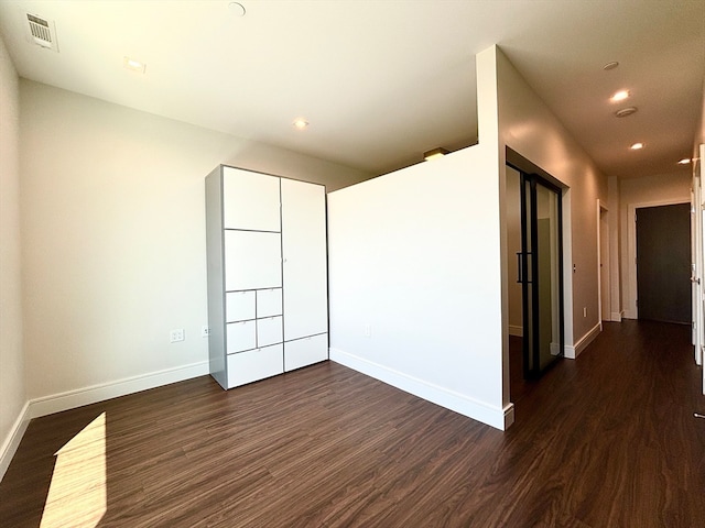 unfurnished room with hardwood / wood-style floors