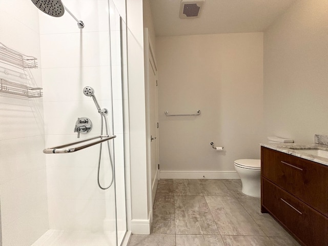 bathroom with a tile shower, vanity, toilet, and tile floors