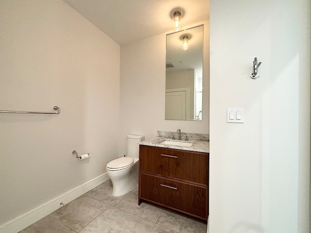 bathroom featuring tile floors, large vanity, and toilet