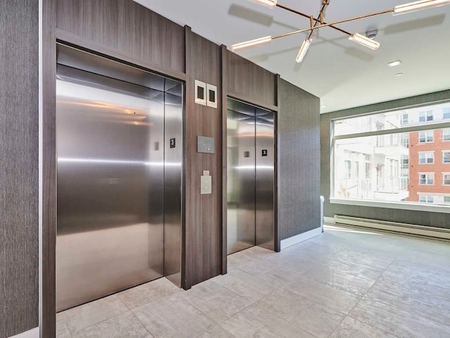 interior space featuring a chandelier, light tile flooring, and elevator