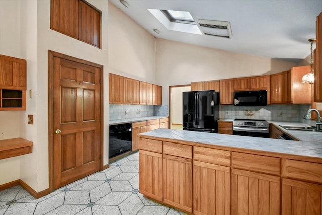 kitchen with tile countertops, backsplash, sink, and black appliances