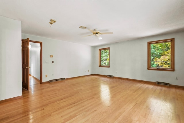 empty room featuring ceiling fan and light hardwood / wood-style flooring