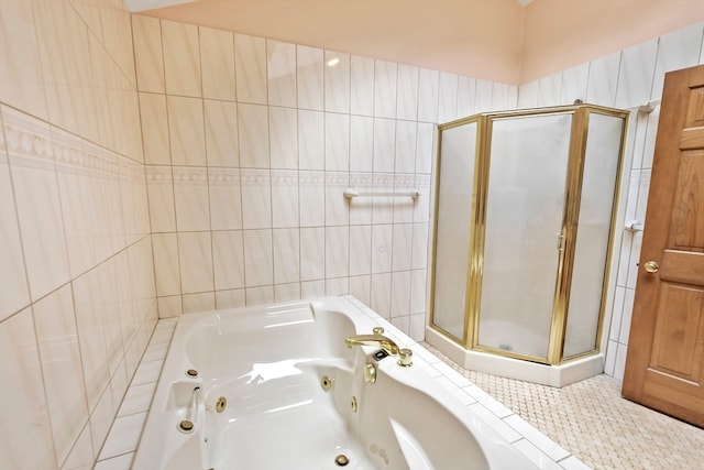 bathroom with independent shower and bath, tile walls, and tile patterned floors