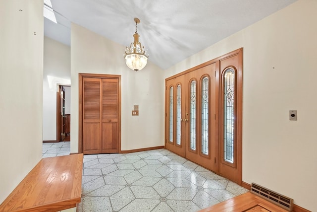 foyer entrance featuring an inviting chandelier