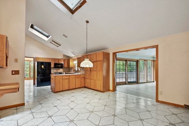 kitchen with pendant lighting, a skylight, a healthy amount of sunlight, and black appliances