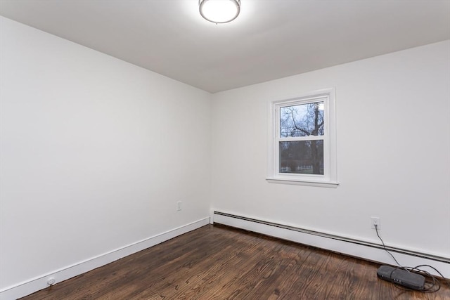 empty room featuring a baseboard radiator and dark wood-type flooring