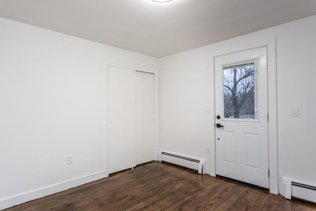 foyer with dark hardwood / wood-style flooring and a baseboard radiator