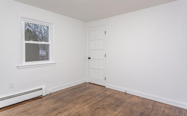 empty room with a baseboard radiator and dark wood-type flooring