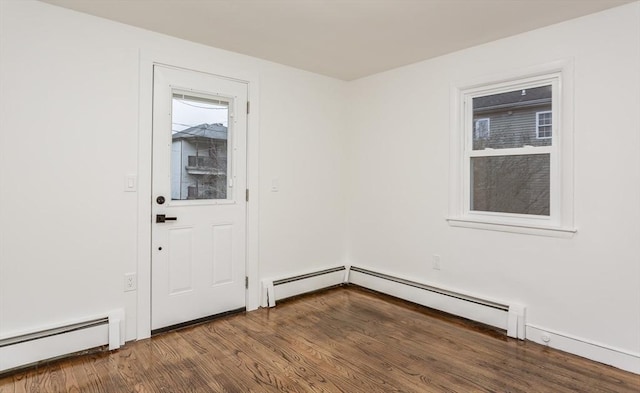 interior space with baseboard heating and dark hardwood / wood-style flooring