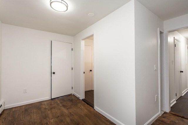 hall featuring dark hardwood / wood-style flooring and a baseboard heating unit