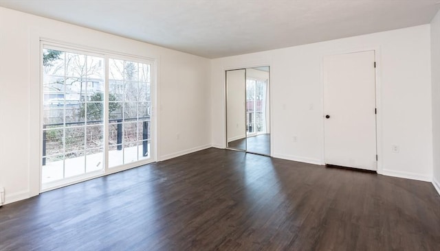 unfurnished room featuring dark hardwood / wood-style flooring