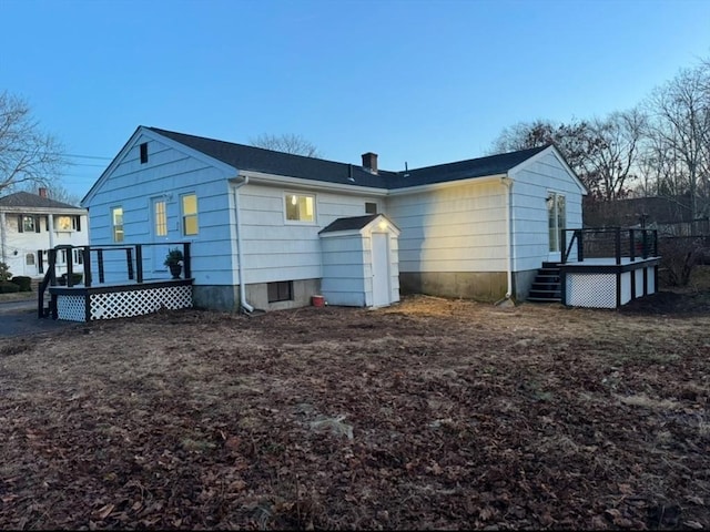 rear view of house with a wooden deck