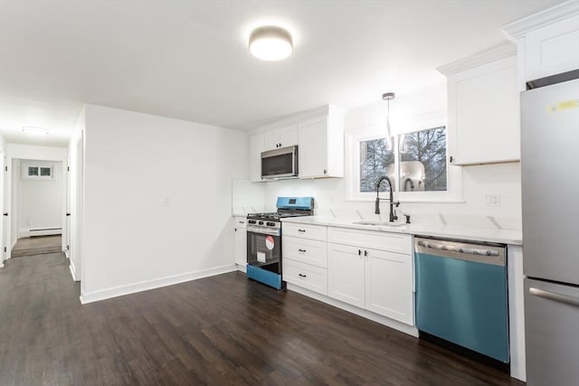 kitchen with pendant lighting, sink, dark hardwood / wood-style flooring, white cabinetry, and stainless steel appliances