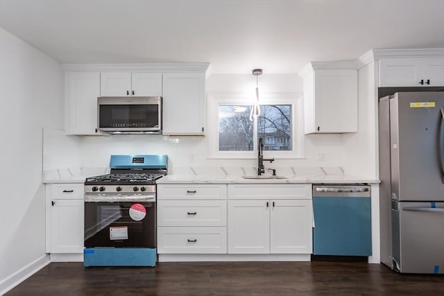 kitchen with white cabinets, decorative light fixtures, sink, and stainless steel appliances