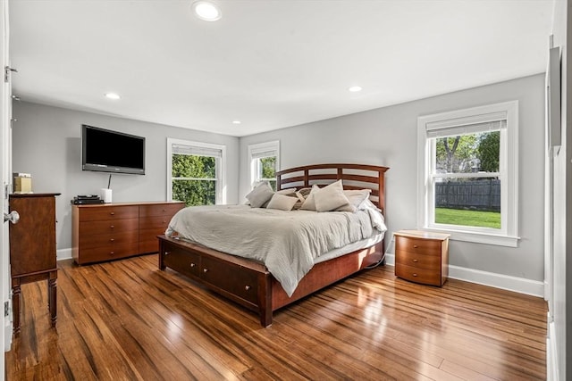 bedroom with baseboards, recessed lighting, and wood finished floors