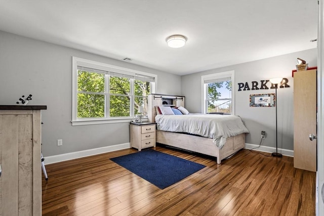 bedroom featuring baseboards and wood finished floors