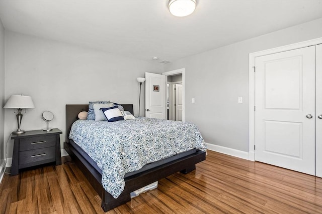 bedroom featuring baseboards and wood finished floors