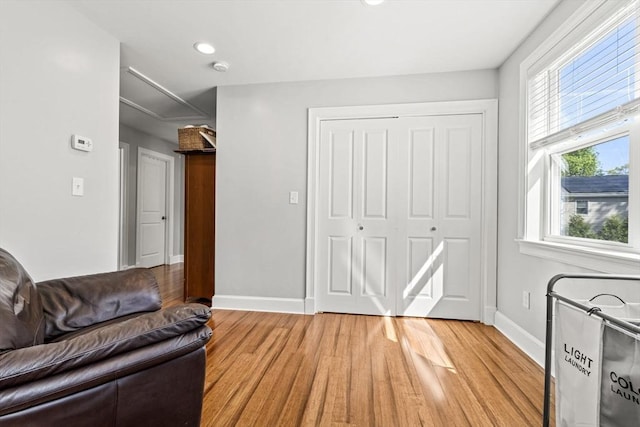 living room featuring baseboards, plenty of natural light, and light wood-type flooring