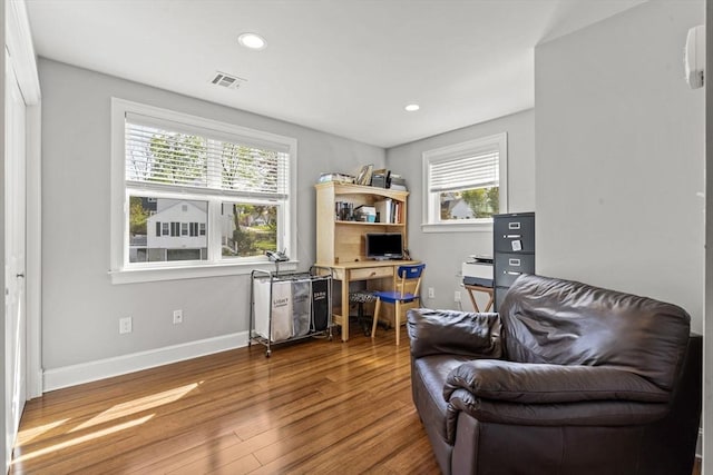 living area with visible vents, recessed lighting, baseboards, and wood finished floors