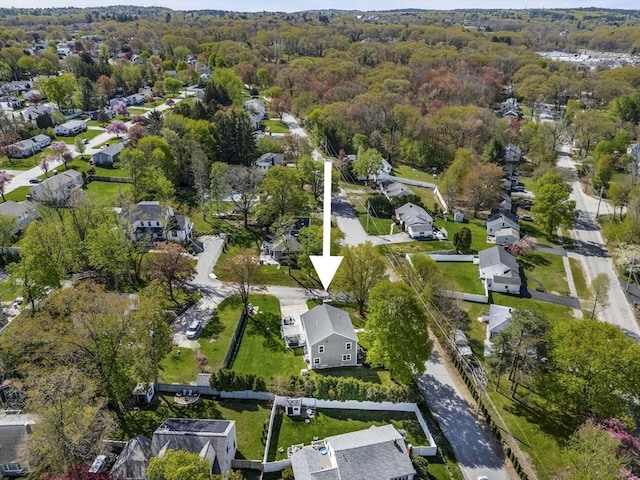 bird's eye view featuring a residential view and a wooded view