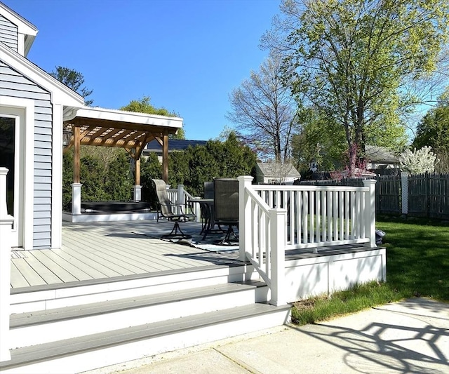 deck featuring fence and a pergola