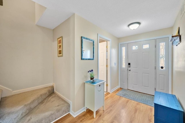 entryway with light hardwood / wood-style floors