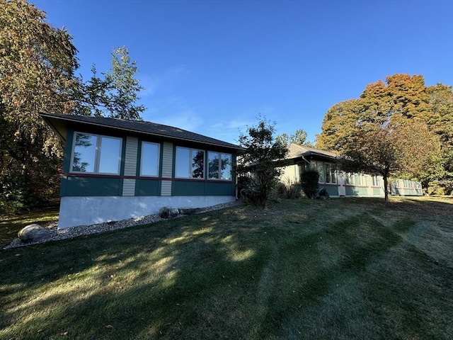 view of property exterior with a yard