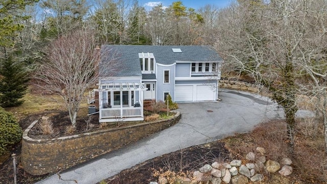 view of front of home featuring aphalt driveway, a shingled roof, and an attached garage