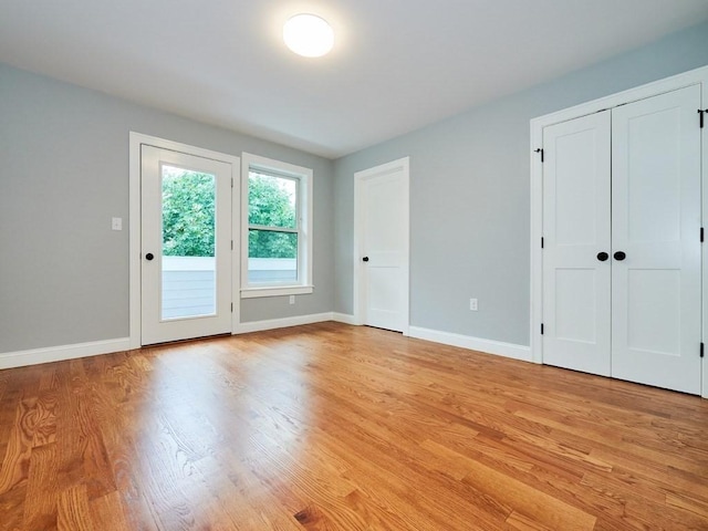 223 Saratoga St Unit U203, Boston, MA 02128 - unfurnished bedroom featuring light wood-style floors, two closets, access to outside, and baseboards