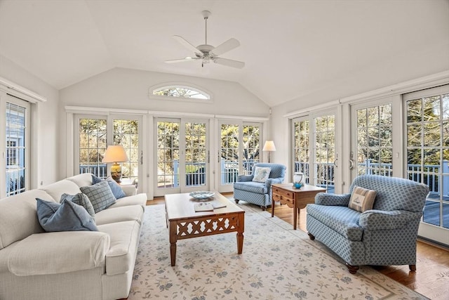 sunroom with ceiling fan and vaulted ceiling