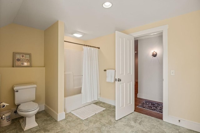 bathroom featuring shower / bath combination with curtain and toilet