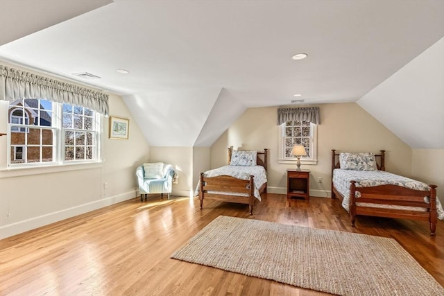 bedroom featuring lofted ceiling and hardwood / wood-style floors