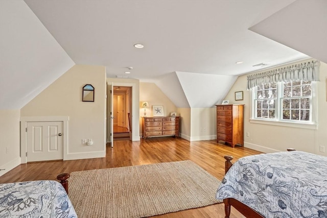 bedroom featuring hardwood / wood-style flooring and lofted ceiling