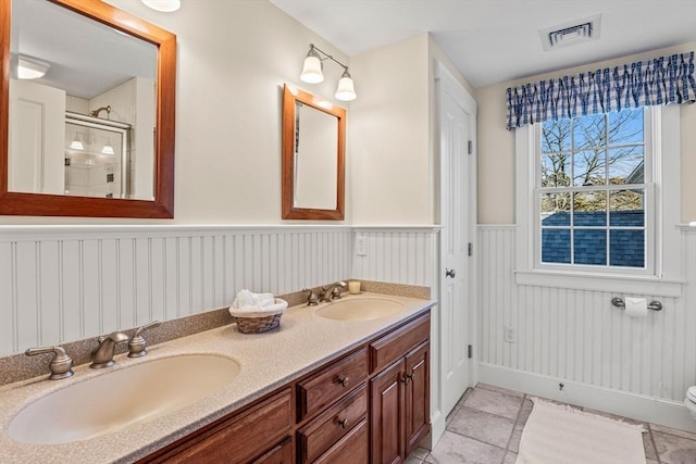 bathroom with walk in shower, vanity, and toilet