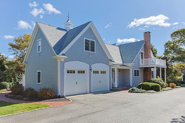 view of front of home featuring a balcony and a garage