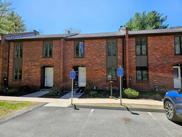 12 Sutton Ct Unit 12, Amherst, MA 01002 - view of property featuring brick siding and uncovered parking