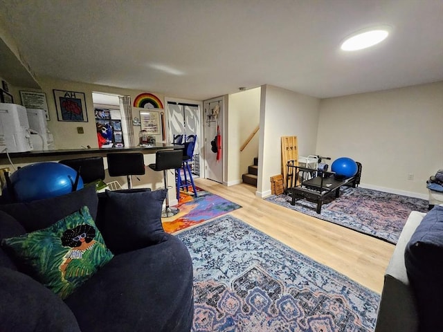 12 Sutton Ct Unit 12, Amherst, MA 01002 - living room featuring stairs, wood finished floors, and baseboards