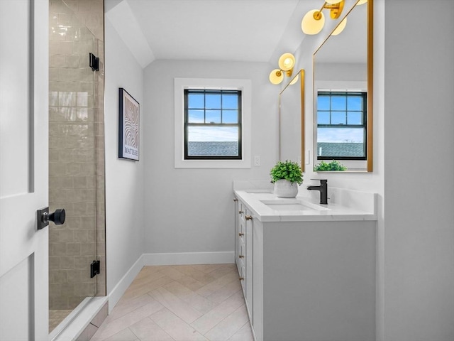 bathroom featuring vanity, walk in shower, and a wealth of natural light