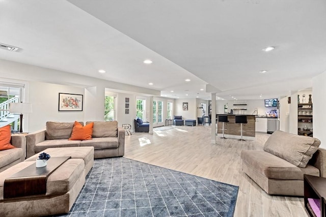 living room featuring recessed lighting, visible vents, and light wood finished floors