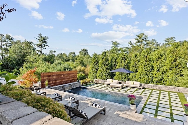 outdoor pool with outdoor lounge area and a patio area