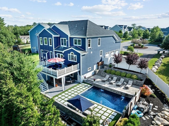 back of property featuring a patio area, a fenced backyard, stairs, and a fenced in pool