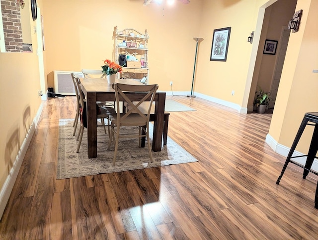 dining room with wood-type flooring and ceiling fan