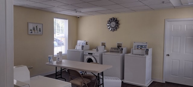 clothes washing area featuring washer and dryer and dark hardwood / wood-style flooring