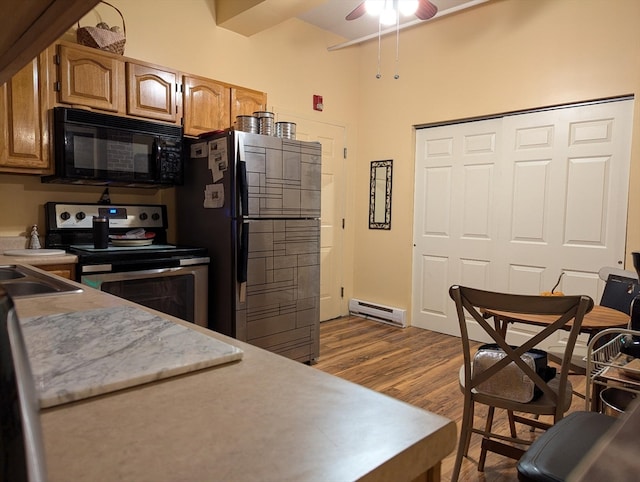 kitchen featuring black appliances, ceiling fan, wood-type flooring, sink, and a baseboard radiator