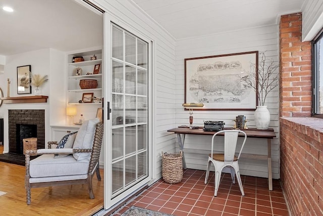 office space with built in features and a fireplace