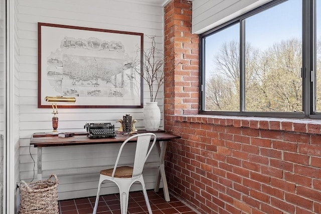 office area with dark tile patterned floors and wooden walls