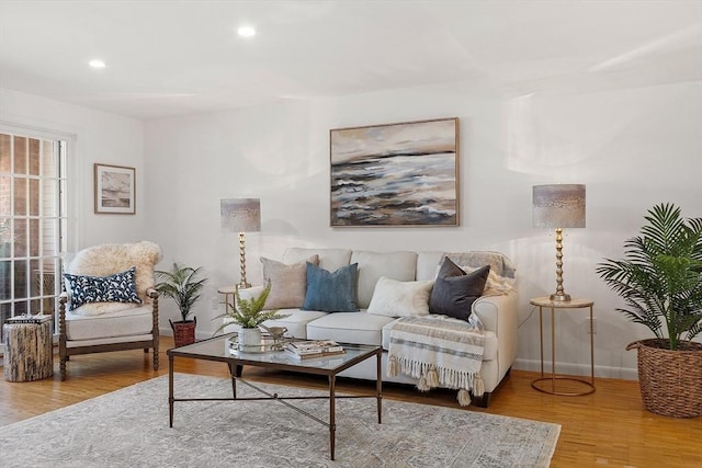 living room featuring baseboards, recessed lighting, and wood finished floors