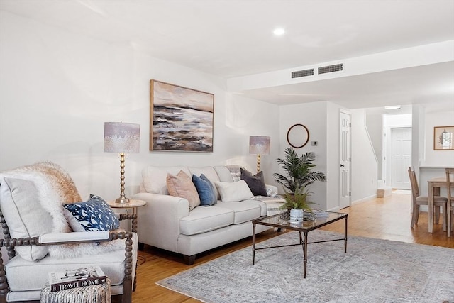 living room featuring baseboards, recessed lighting, wood finished floors, and visible vents